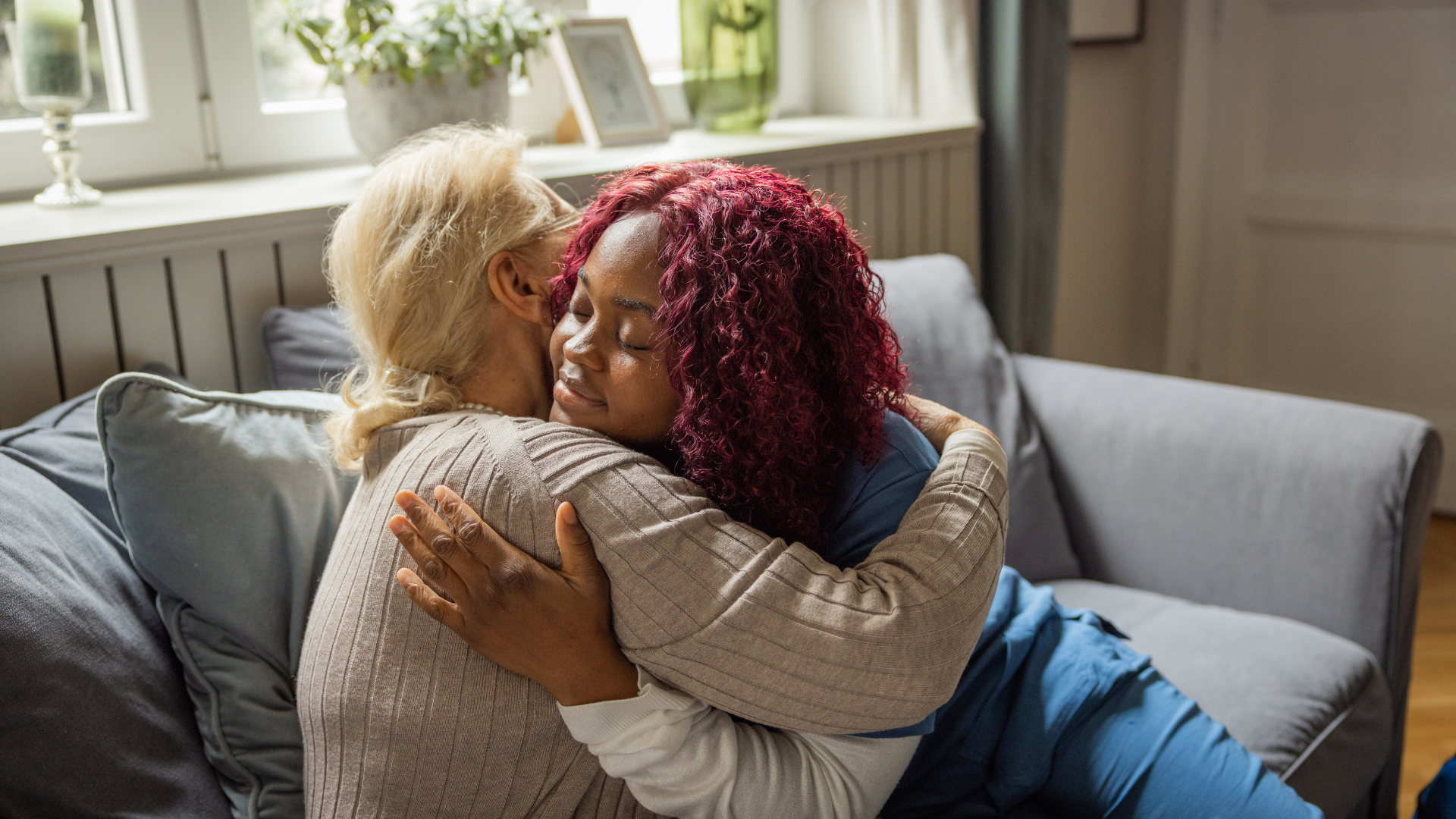 A carer and the lady she supports sharing a laugh